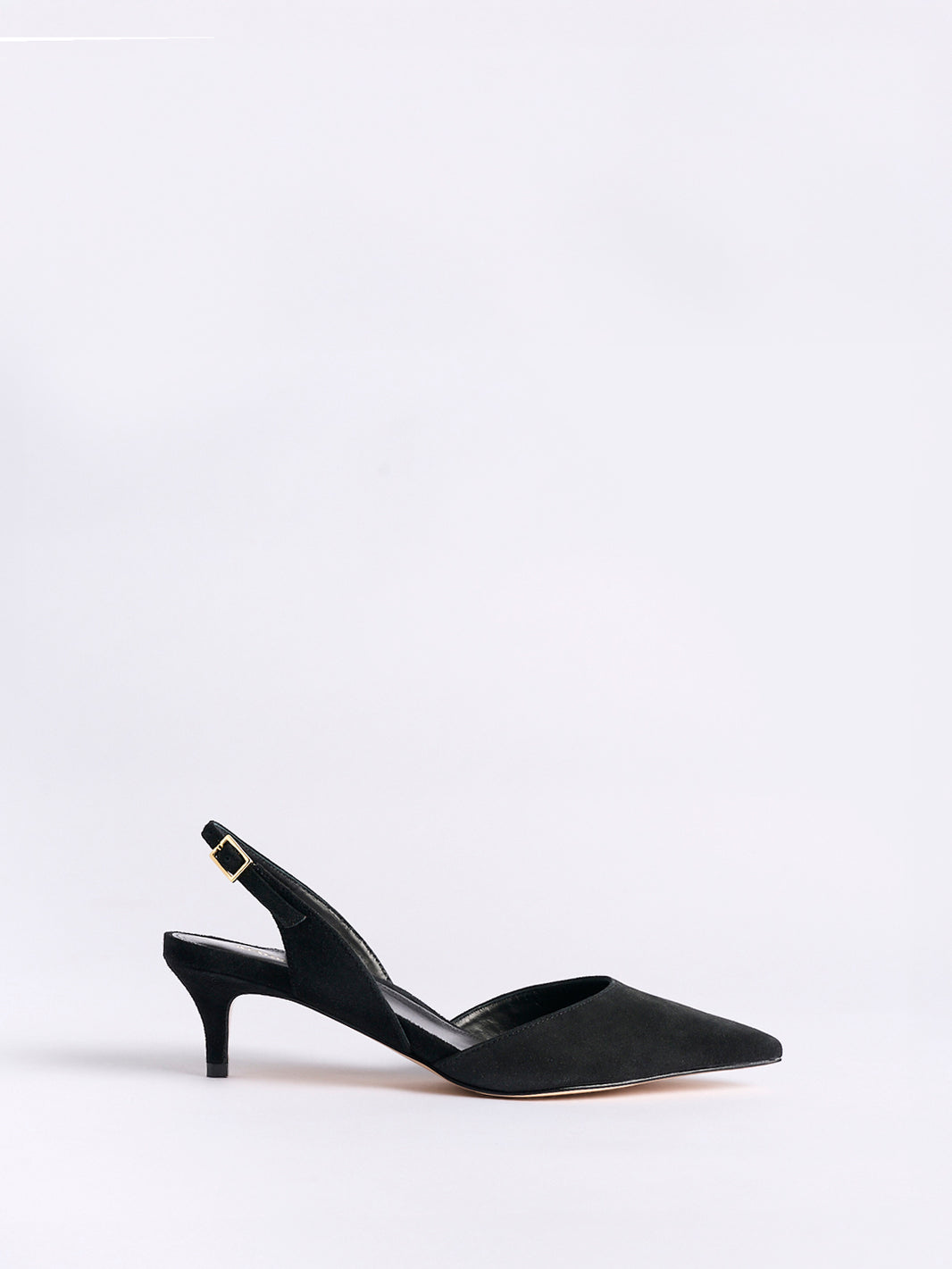 Profile view of a black suede slingback kitten heel with a pointed toe.