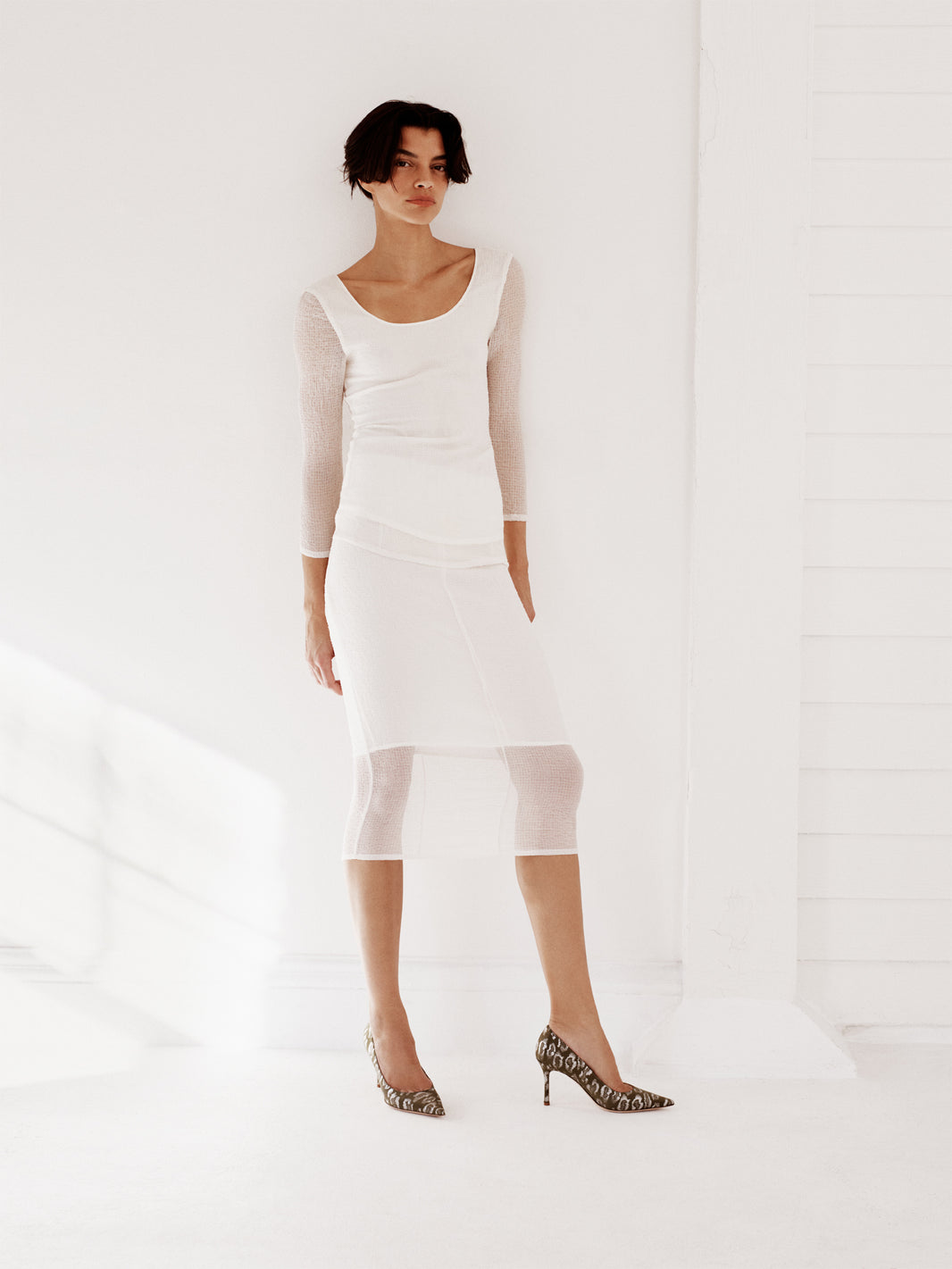 Olive green leopard silk high stiletto heel pump with a pointed toe, shown on a model.