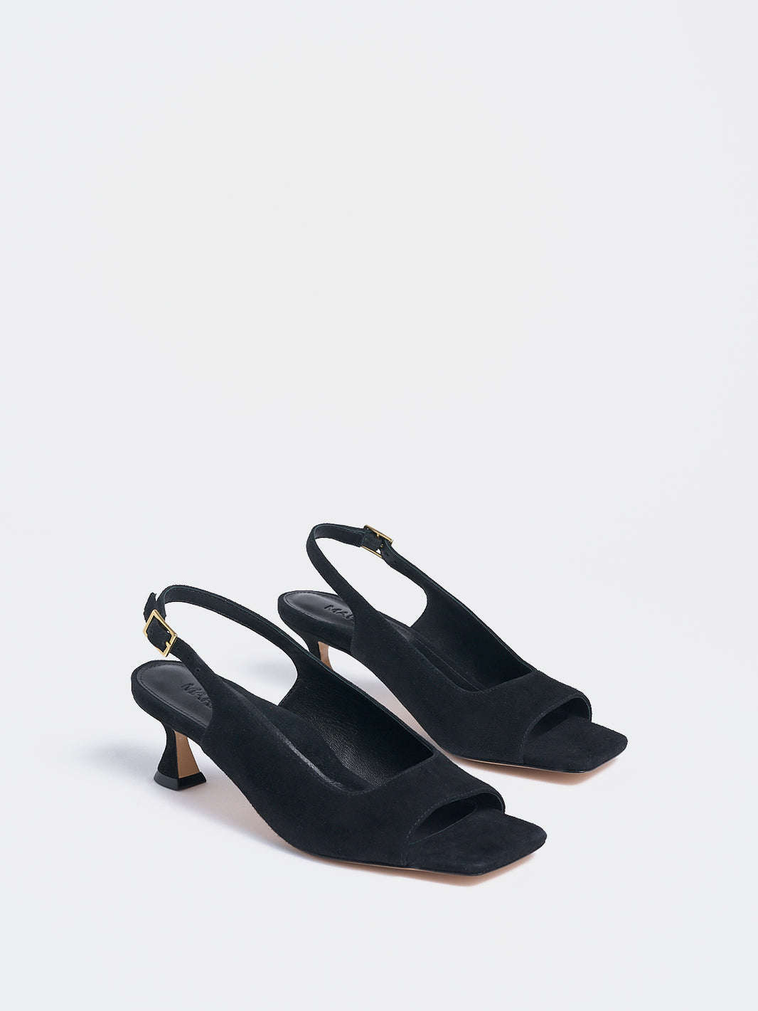 Angle view of a pair of black suede slingback sandals with a flared kitten heel and square toe detail.