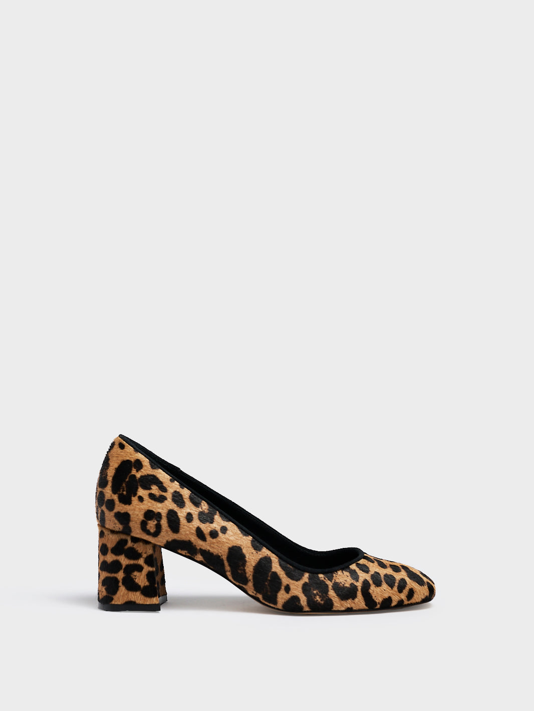 Profile view of a leopard hair calf  leather block heel pump with a rounded toe.