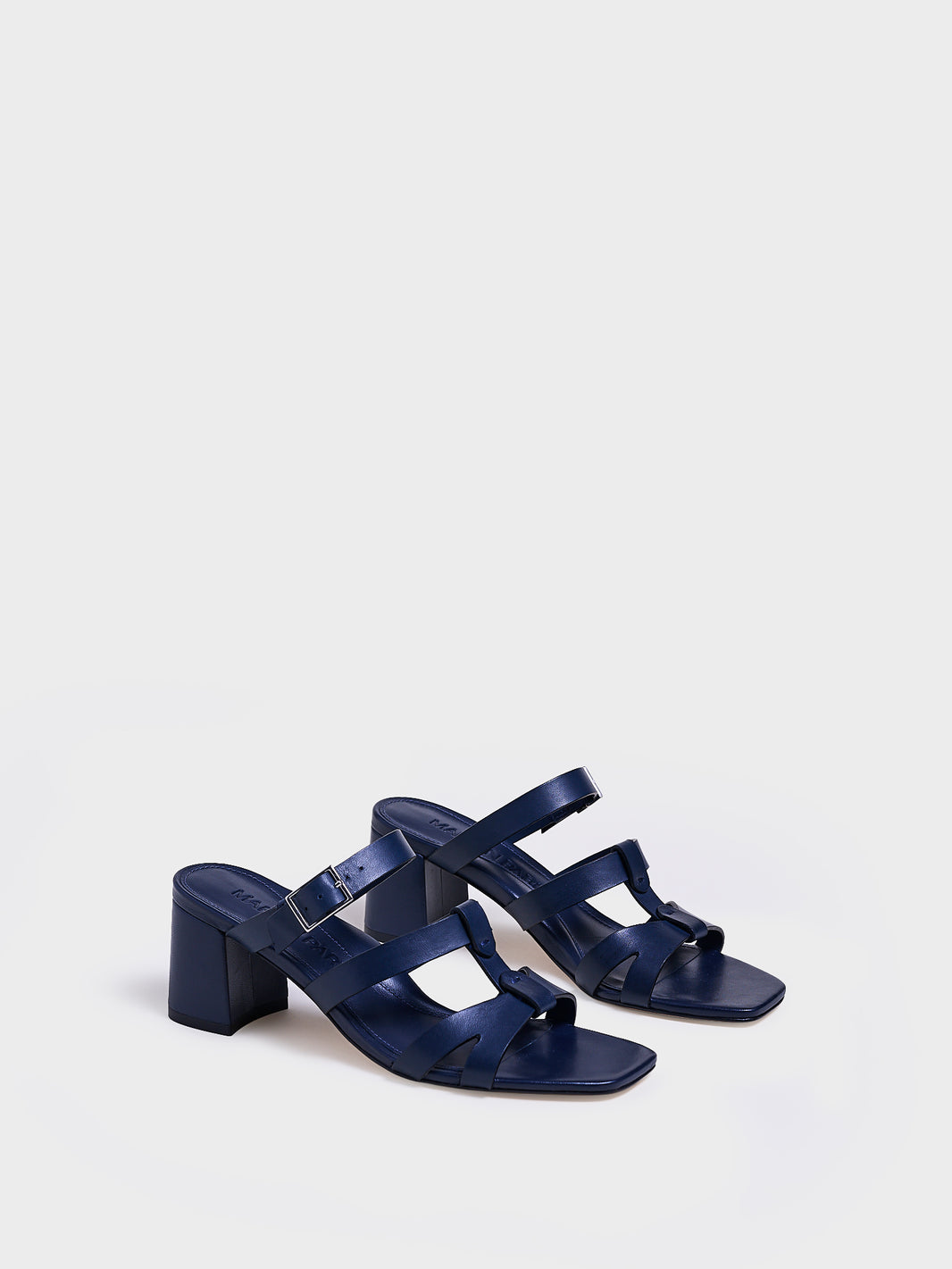 Angle view of a pair of navy nappa leather gladiator block heel sandals.