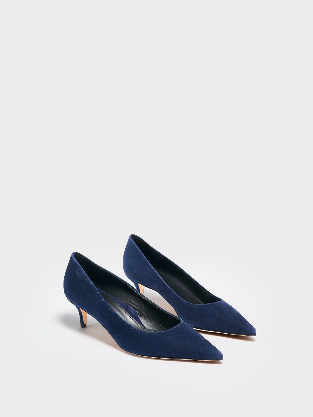 Angle view of a pair of navya suede kitten stiletto heel pump with a pointed toe.