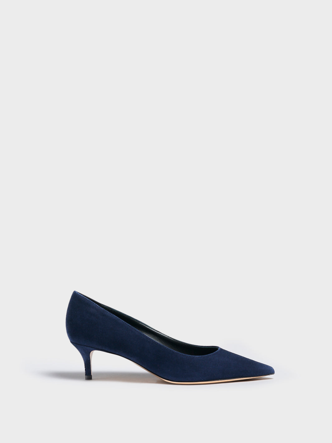 Profile view of a navy suede kitten stiletto heel pump with a pointed toe.