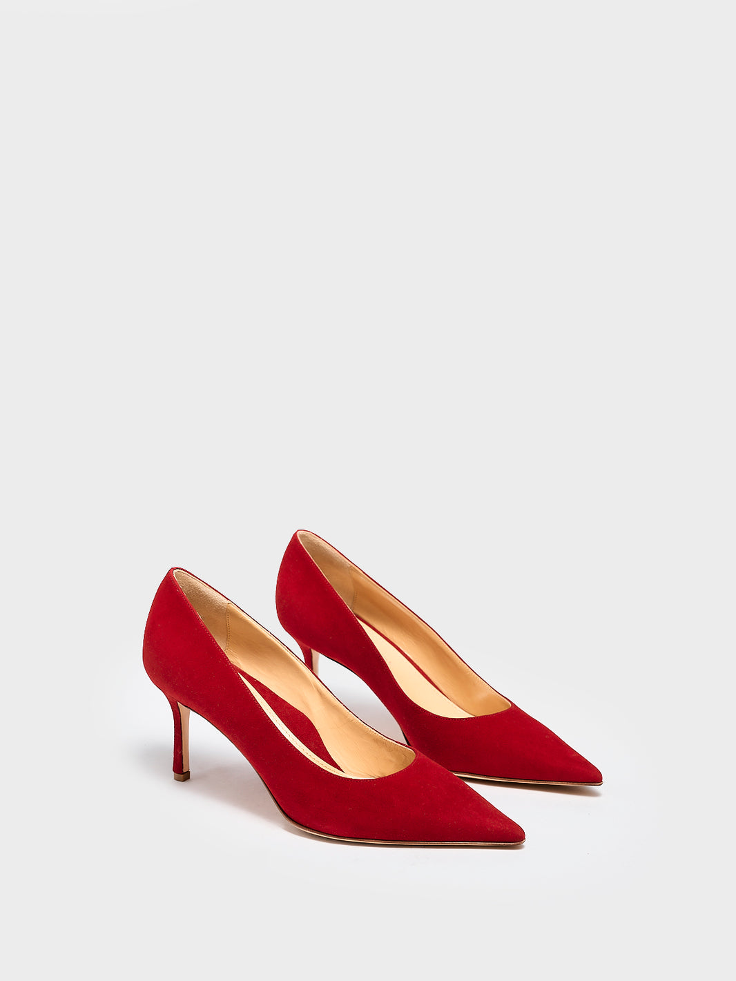 Angle view of a pair of red suede stiletto heel pumps with a pointed toe.