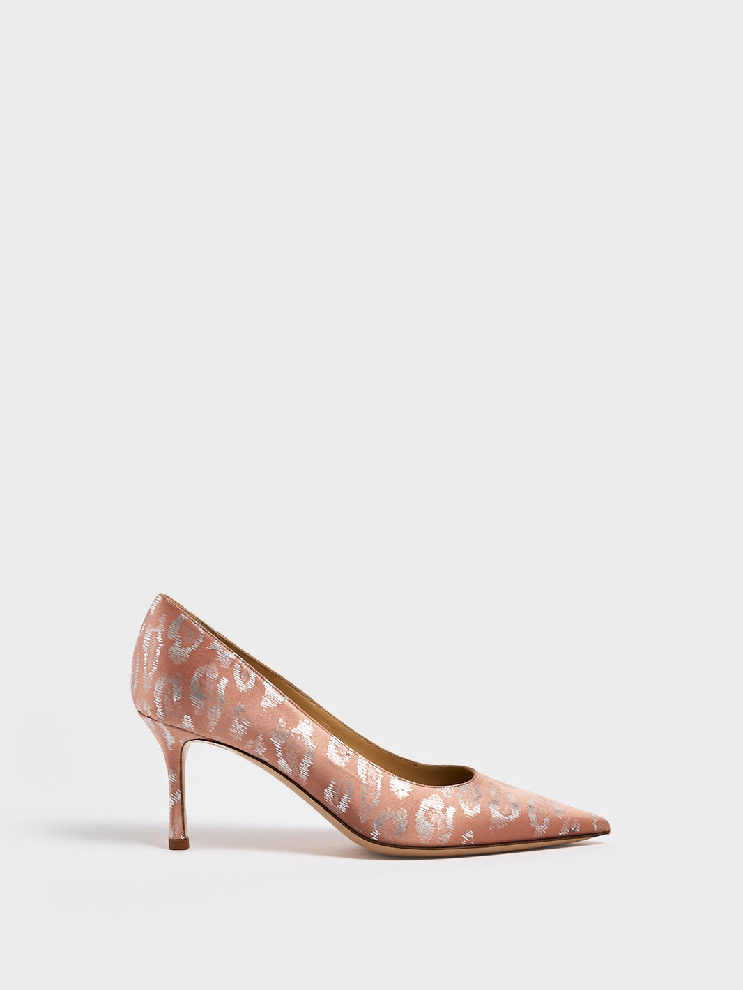 Profile view of a blush leopard silk stiletto heel pump with a pointed toe.