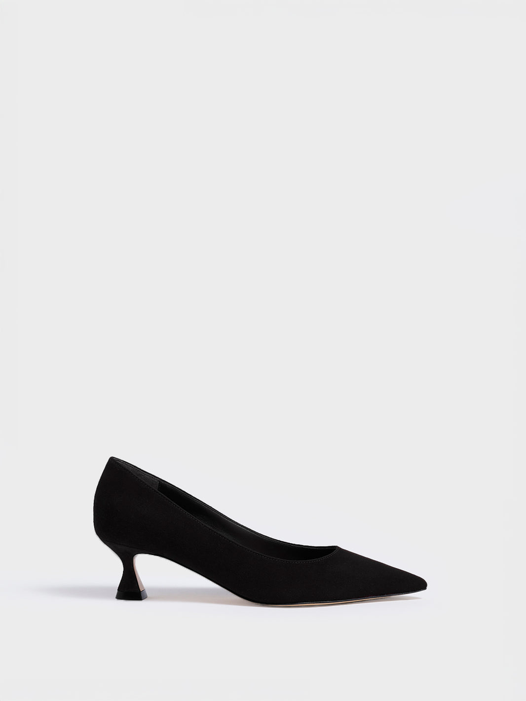 Profile view of a black suede flared kitten heel pump with a pointed toe.