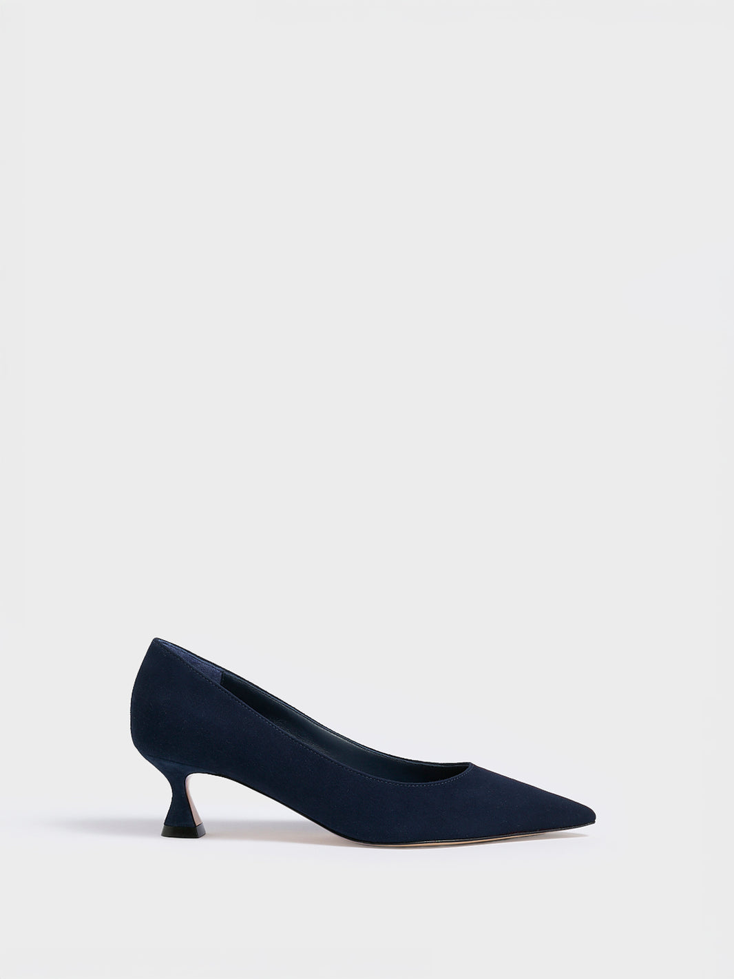 Profile view of a navy suede flared kitten heel pump with a pointed toe.