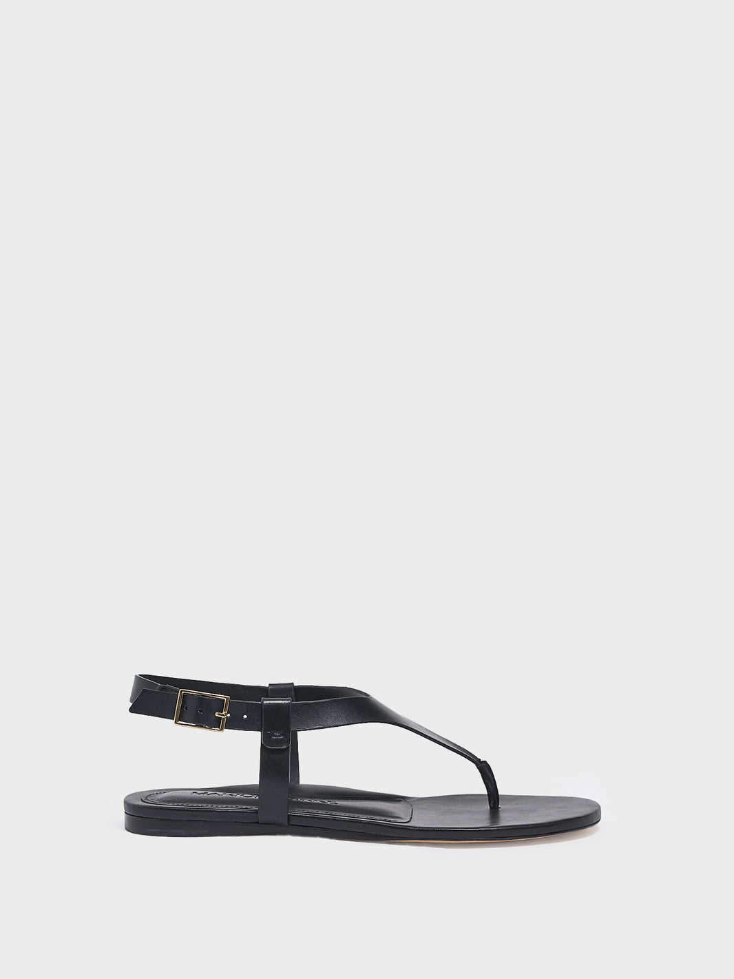 Profile view of a black leather thong sandal with a clean design and adjustable ankle strap. 